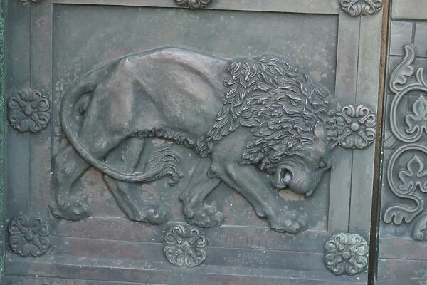 Lion detail of bronze cathedral door in historic town, Our Lady Maria Cathedral (Vor Frue Maria Domkirke), Ribe