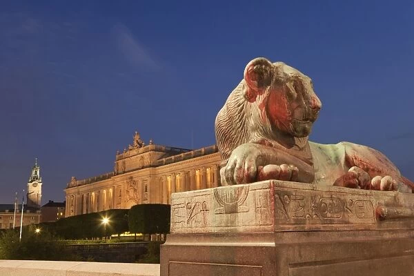 Lion sculpture and royal palace illuminated at night, Royal Palace, Stockholm, Sweden, September