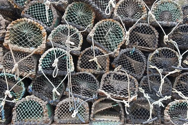 Lobster pots on quayside of harbour, Burnmouth, Scottish Borders, Scotland, july