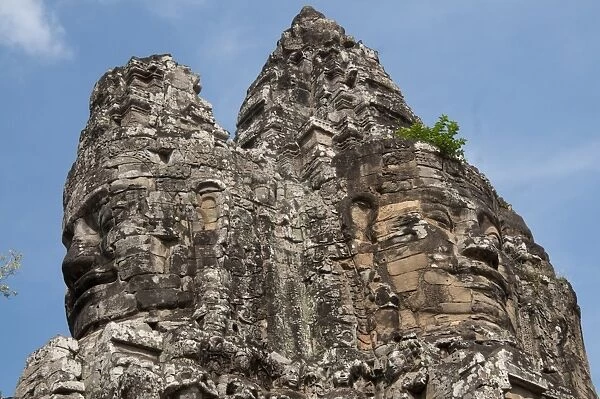 Top of major gate tower with large sculptures of heads, at Khmer temple, Angkor Thom, Siem Riep, Cambodia