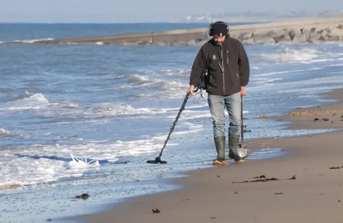 Framed Print : Man using metal detector on beach, near Granville, Manche, Normandy, France, December Framed Print : Man using metal detector on beach, near Granville, Manche, Normandy, France, December