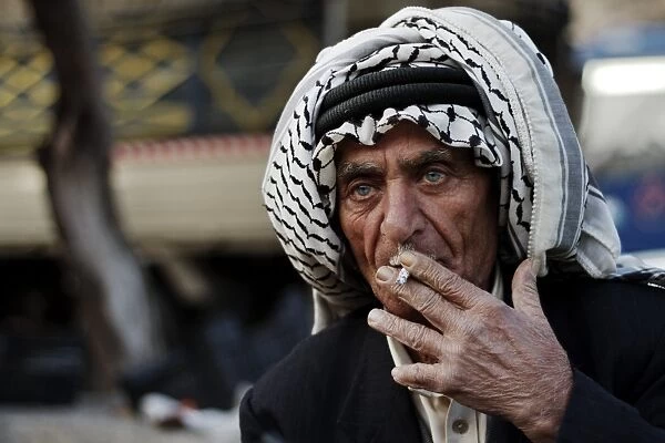 Market vendor, man smoking cigarette, close-up of head, Amman, Jordan, november