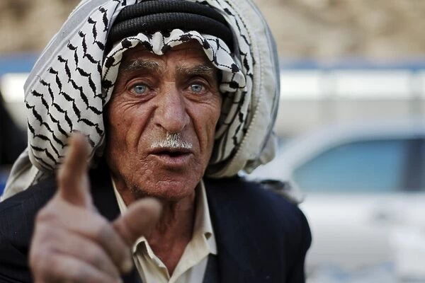 Market vendor, man talking, close-up of head, Amman, Jordan, november