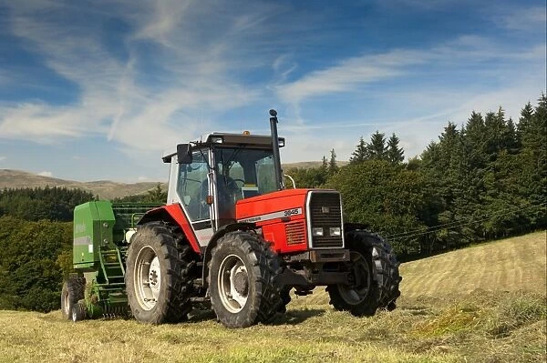 Massey Ferguson tractor with McHale baler, round baling silage in meadow, Yorkshire Dales, Yorkshire, England