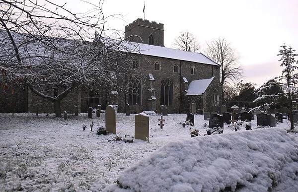 Medieval church and graveyard in snow, St. Marys Church, Haughley, Suffolk, England, november