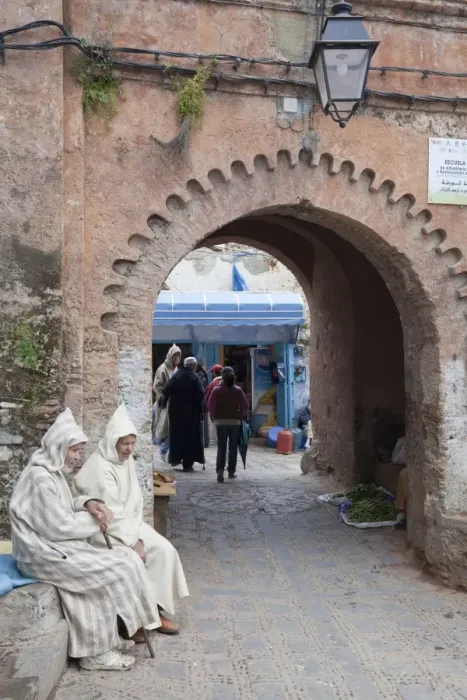Framed Print : Men wearing djellaba sitting beside medina archway in city, Chefchaouen, Morocco, april