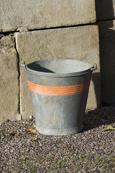 Metal bucket in farmyard, Sweden, october