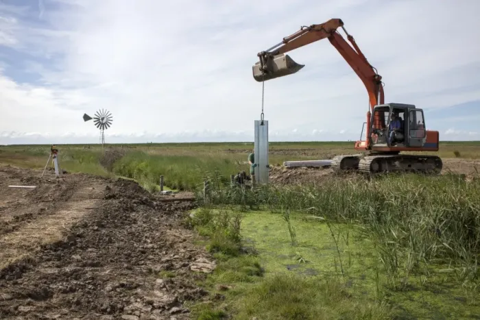 Framed Print : Metal pilings being fitting to make a sluice gate to retain water at Deepdale Marsh, Burnham Deepdale, North Norfolk