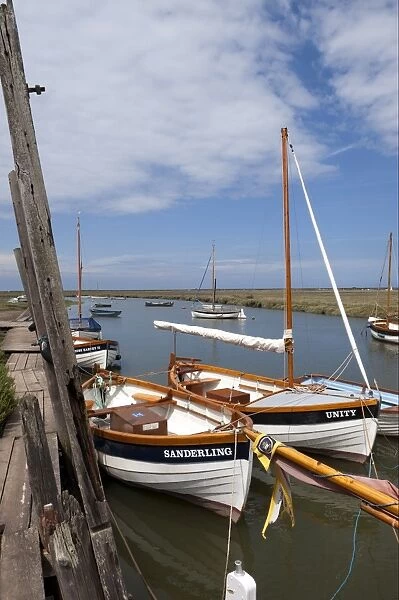 Moored sailing boats in coastal creek, Blakeney Quay, Norfolk, England, july