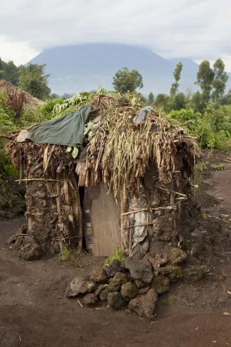 Framed Print : Mud hut in Pygmy village, with volcano in background, Virunga Mountains, Uganda