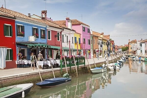 Multi-coloured restaurant and houses along canal waterfront, Burano Island, Venetian Lagoon, Venice, Veneto, Italy, May
