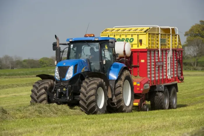 Framed Print : New Holland tractor with Pottinger forage wagon, picking up grass in silage field, Northumberland, England, May