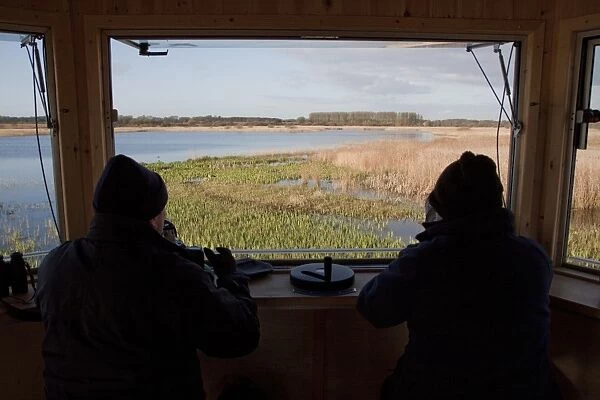 The New Island Mere hide at RSPB Minsmere, birdwatchers looking west over reed beds
