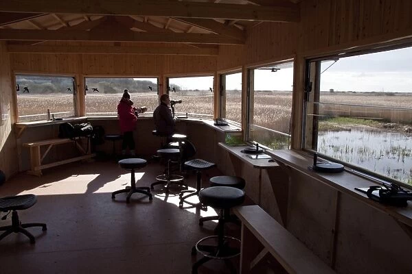 The New Island Mere hide at RSPB Minsmere, birdwatchers looking east over reed beds