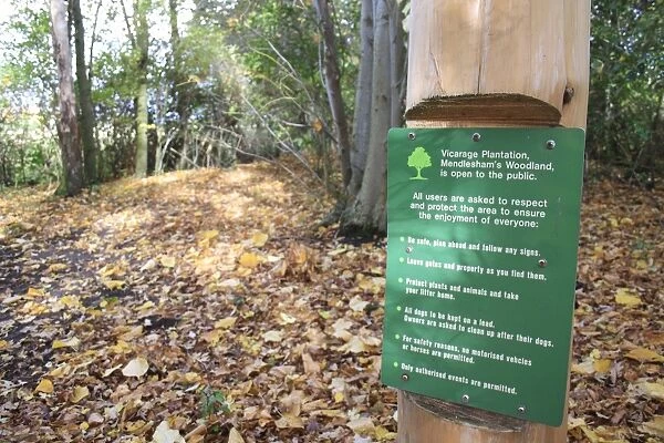 Notice with rules on post in woodland, Vicarage Plantation, Mendlesham, Suffolk, England, november