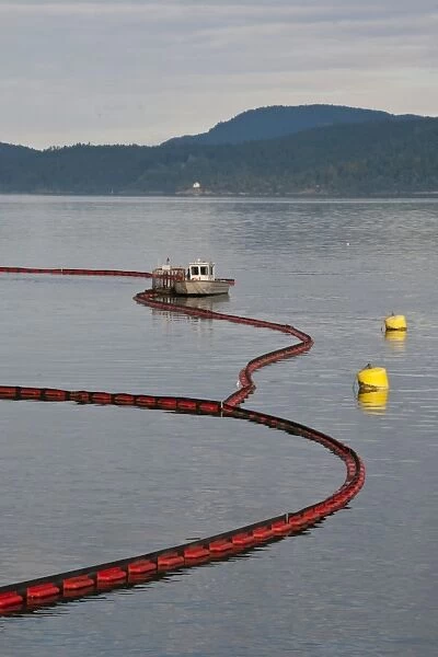 Oil boom on sea around oil refinery, Satellite Channel, Vancouver Island, British Columbia, Canada, december