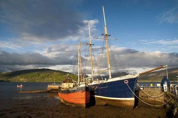 Two old boats grounded at low tide in harbour, Inveraray, Loch Fyne, Argyll, Scotland, May