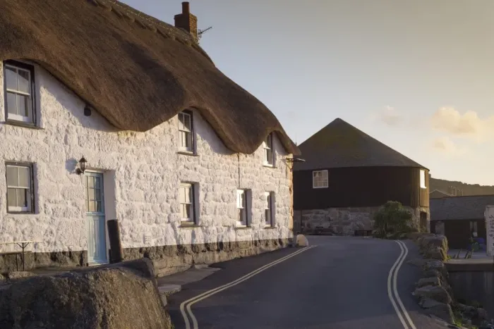 Framed Print : Old fishermans cottage and The Roundhouse (old capstan house) in coastal village at sunset, Sennen Cove, Sennen Framed Print : Old fishermans cottage and The Roundhouse (old capstan house) in coastal village at sunset, Sennen Cove, Sennen