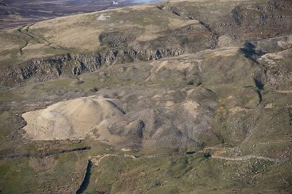 Old mine waste spoil heaps on edge of dales moorland, Arkengarthdale Moor, North Yorkshire, England, March