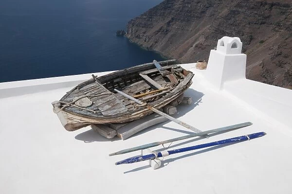 Old weathered rowing boat on house roof terrace, Fira, Santorini, Cyclades, Aegean Sea, Greece, September