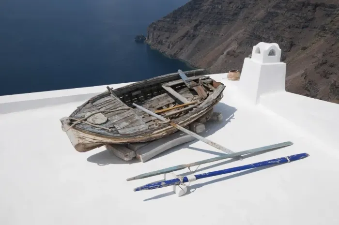 Framed Print : Old weathered rowing boat on house roof terrace, Fira, Santorini, Cyclades, Aegean Sea, Greece, September