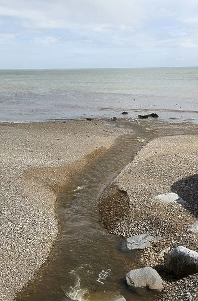 Outlet of the River Sid onto the shingle beach of Sidmouth in Devon