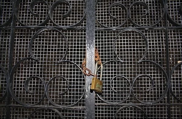 Padlock and chain on church porch gate, St. Marys Church, Market Weston, Suffolk, England, october