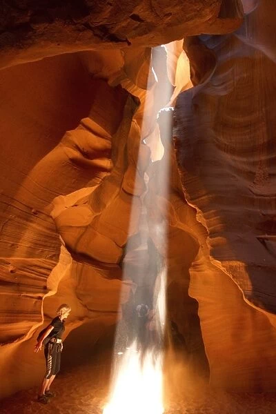 People caught in Light beam in Upper Antelope Canyon was formed by erosion of Navajo Sandstone