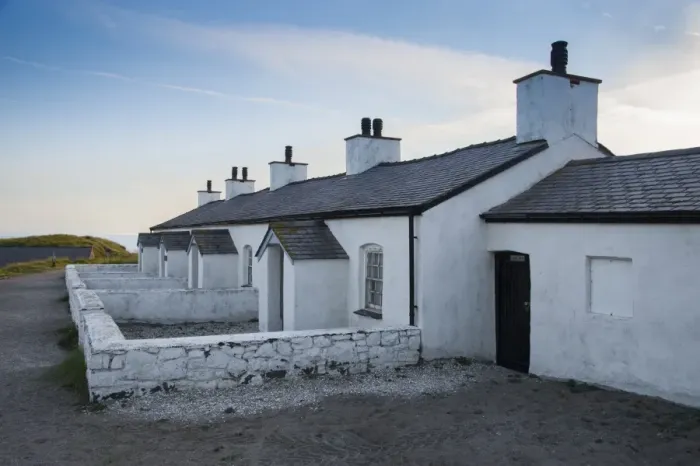Framed Print : Pilot cottages used to service pilot boats and lifeboats on tidal island, Llanddwyn Island