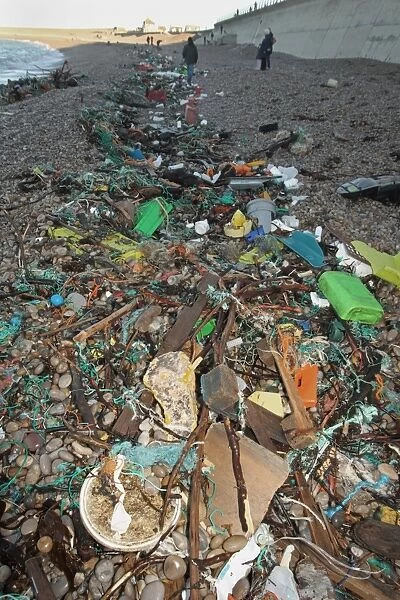 Plastic rubbish washed up on beach strandline, Chesil Beach, Dorset, England, January