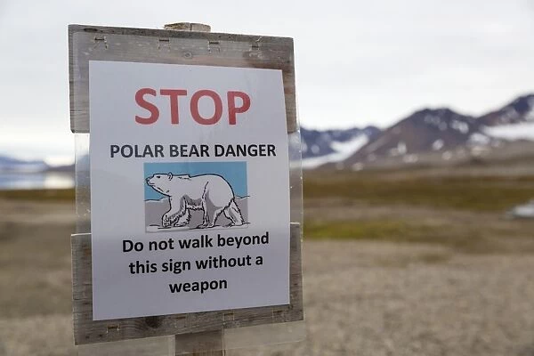 Polar Bear (Ursus maritimus) warning sign, Stop, Polar Bear Danger, Do not walk beyond this sign without a weapon