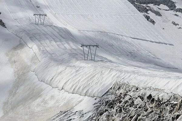 Protective textile covering to delay snow melting on skiing slope with ski lift, Presena Glacier, Italian Alps, Italy