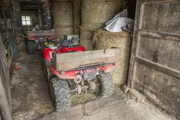 Two Quadbikes in barn on farm, Lancashire, England, August