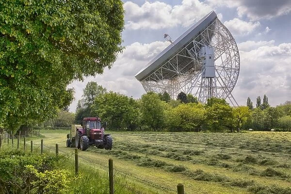 Radio telescope with tractor and baler baling silage in foreground, Lovell Telescope, Jodrell Bank Observatory