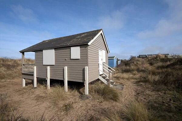 Raised beach hut in coastal sand dunes, Hunstanton, Norfolk, England, February