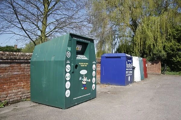 Recycling banks for clothing, paper and glass, in carpark of village hall, Barking Tye, Suffolk, England, april