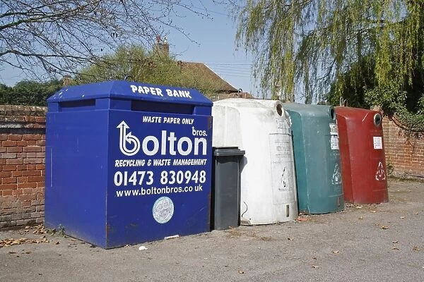 Recycling banks for paper and glass, in carpark of village hall, Barking Tye, Suffolk, England, april