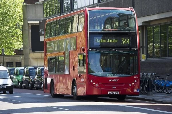 Red bus Clapham Junction 344 driving on city road, London, England, april
