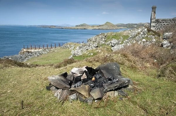 Remnants of fire left by campers near coast, Craignish, Argyll and Bute, Scotland, april