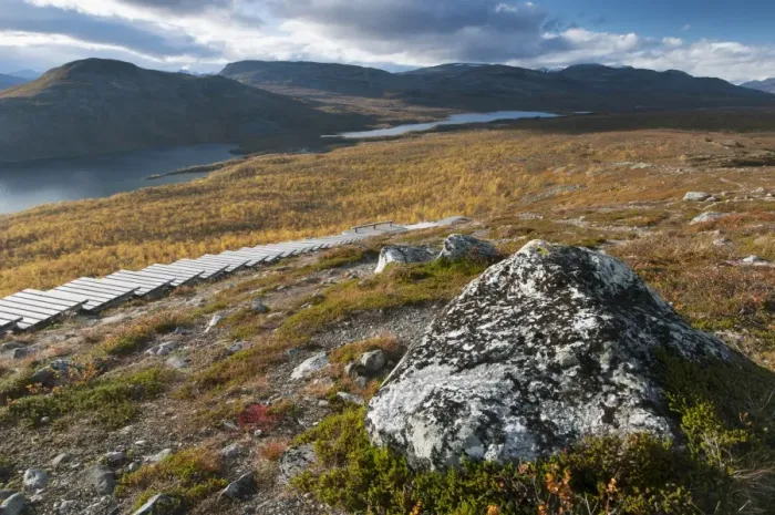 Framed Print : Rock and wooden steps leading to summit of fell, Malla Strict Nature Reserve and Lake Kilpisjarvi in background