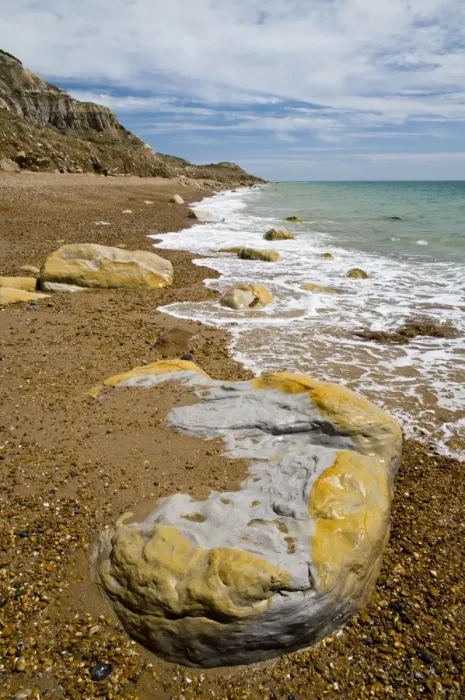 Framed Print : Rocks on beach and in sea under sandstone cliffs, Fairlight Cove, Covehurst Bay, near Hastings, East Sussex, England Framed Print : Rocks on beach and in sea under sandstone cliffs, Fairlight Cove, Covehurst Bay, near Hastings, East Sussex, England
