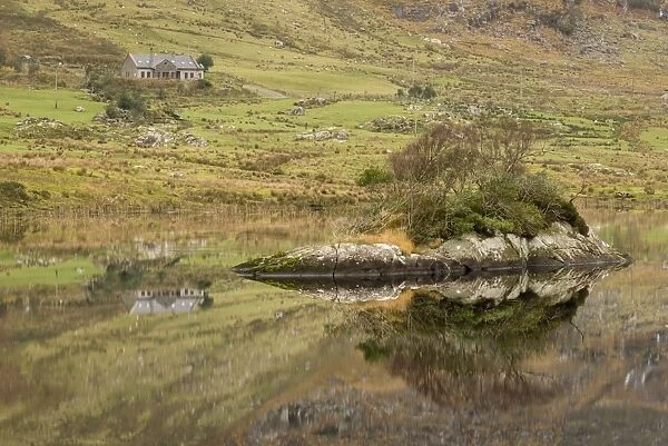 Rocks and building reflected in lake, Cummeenduff Lake, Black Valley, Macgillycuddys Reeks, Killarney, County Kerry