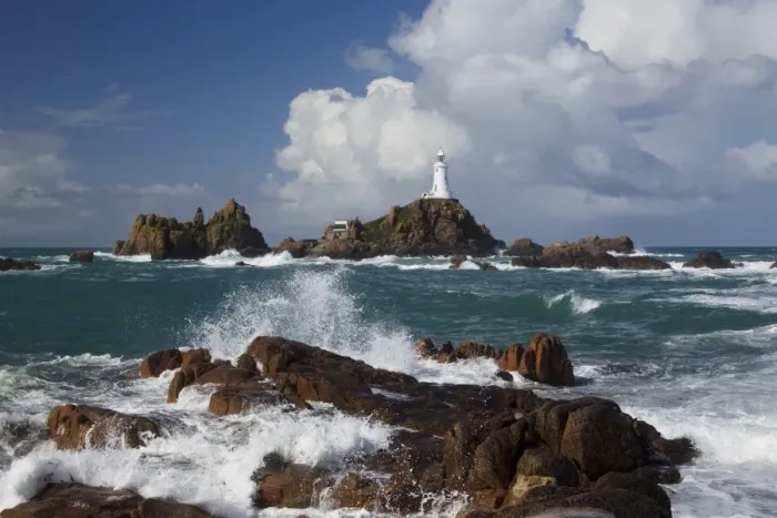 Framed Print : Rocky coastline with lighthouse in background, La Corbiere Lighthouse, La Corbiere, St Framed Print : Rocky coastline with lighthouse in background, La Corbiere Lighthouse, La Corbiere, St