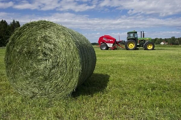 Round silage bale, with John Deere 4455 tractor and Welger baler, Sweden, june