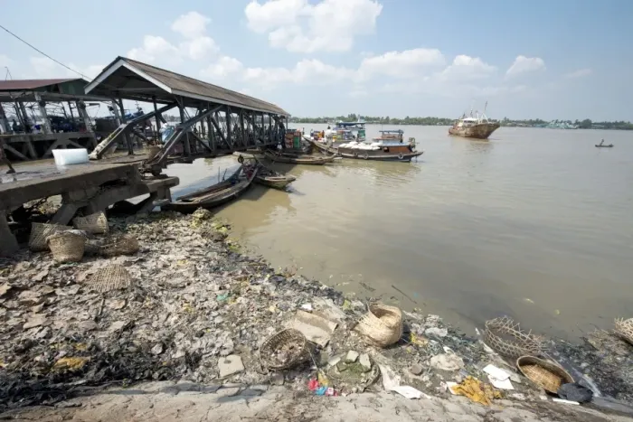 Framed Print : Rubbish at edge of river with jetty and boats, Yangon, Myanmar, March Framed Print : Rubbish at edge of river with jetty and boats, Yangon, Myanmar, March