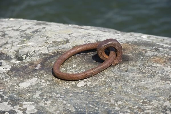 Rusty metal mooring ring in stone, Baltic Sea, Sweden, may