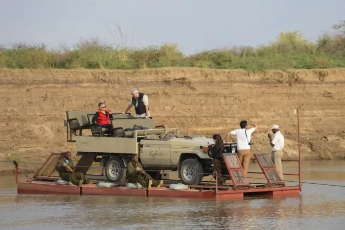 Framed Print : Safari vehicle and tourists crossing river on pontoon, River Luangwa, South Luangwa N. P. Zambia, June