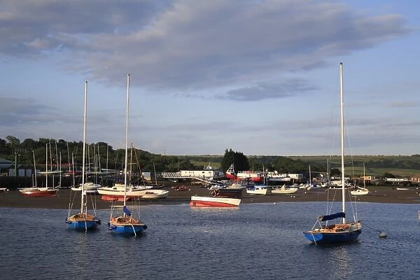 Sailing boats moored in harbour with incoming tide at dawn, Bembridge Harbour, Bembridge, Isle of Wight, England, june