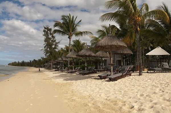 Sandy beach with sunloungers, sunshades and hotel building, Le Telfair Hotel, Bel Ombre, Southwest Mauritius