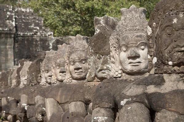 Sculptures of Asuras (demonic monsters) at gate tower of Khmer temple, South Gate, Angkor Thom, Siem Riep, Cambodia